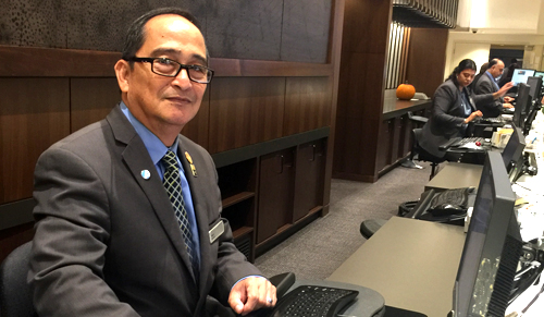 Mario Delmar, a 25-year member at the Hilton San Francisco Union Square tries out the new working conditions at the front desk on October 19, 2016.